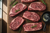 raw steaks with butch block background
